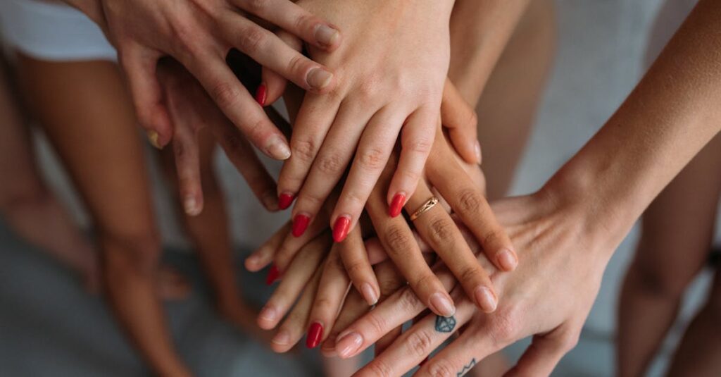 Close-up of diverse hands joined together, symbolizing unity and solidarity.